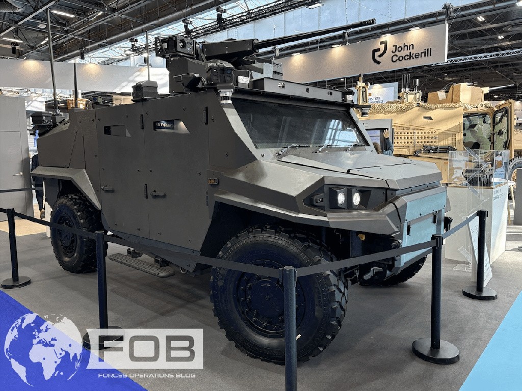 Promodels FAMOUS LAV Arquus scale model in a display case beside another FAMOUS2 program model at Eurosatory 2026.